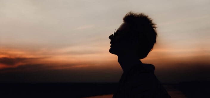 Silhouette of Man Enjoying Nature at Dusk