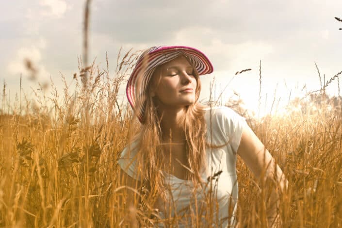 Woman wearing white top and red and white hat