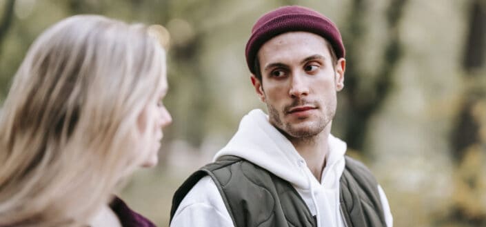 Young couple talking with each other in park