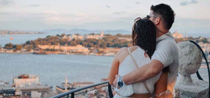 Couple hugging together looking at the view