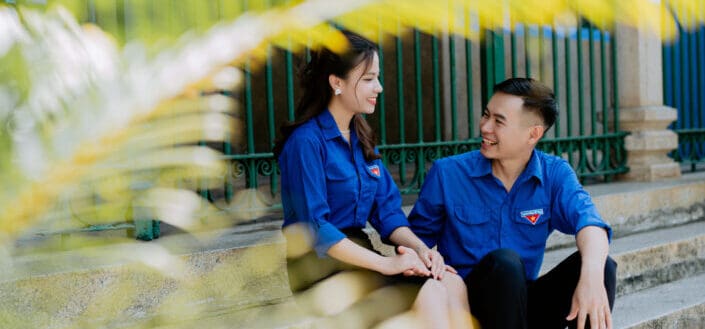 Couple Sitting on Stairs While Smiling