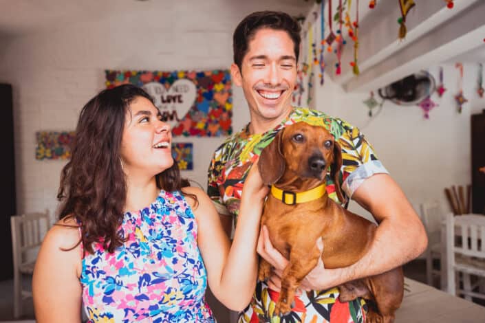 Couple carrying a short coated dog