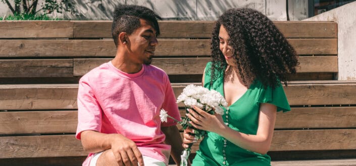 A man giving a woman a bouquet of flowers