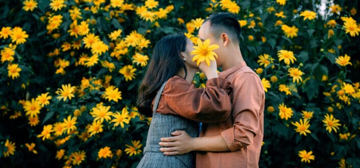 loving couple hugging near blooming shrub