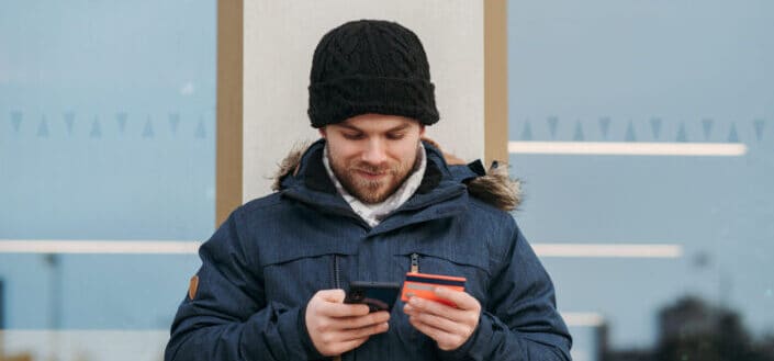 Man entering credit card details on smartphone