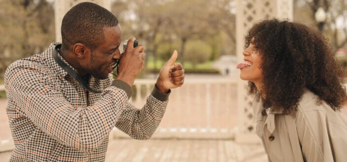 man taking photo of a woman