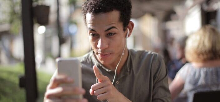 Man using smartphone for video call on street