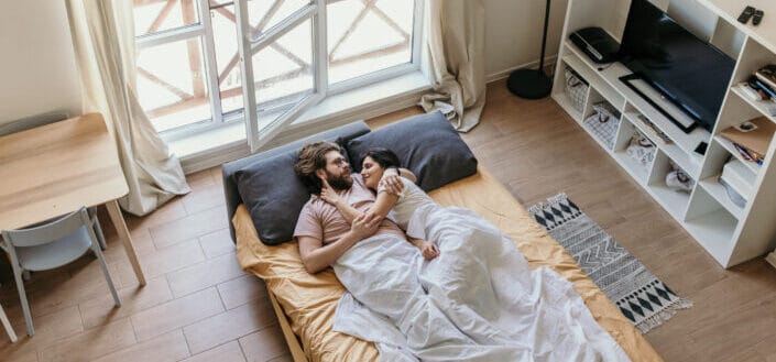 Couple lying on bed together