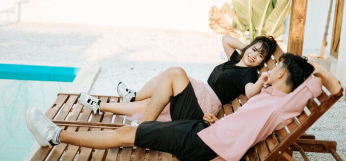 Couple on deckchair near pool