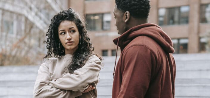 Disappointed couple having argument on street