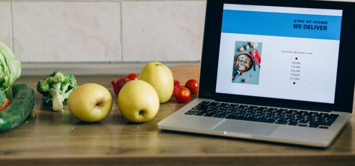 Fruits and vegetables near the laptop