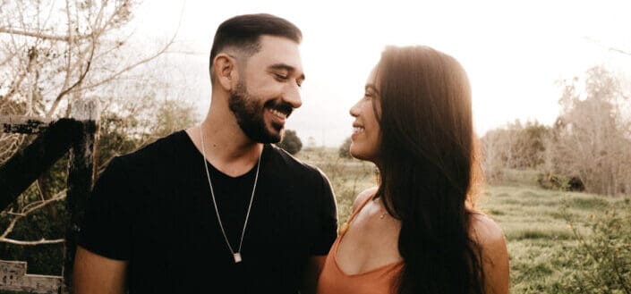 Couple smiling at each other while walking outside