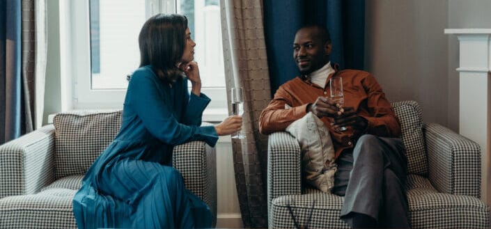 Couple exchanging looks while drinking wine