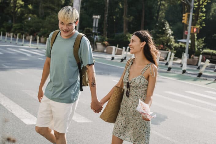 young couple strolling on crosswalk