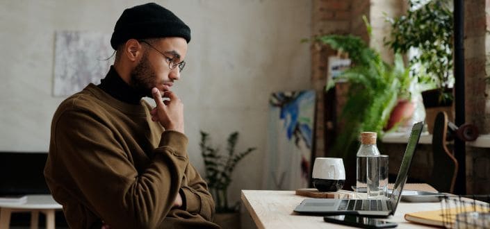 Man Thinking While Looking at the Screen of a Laptop