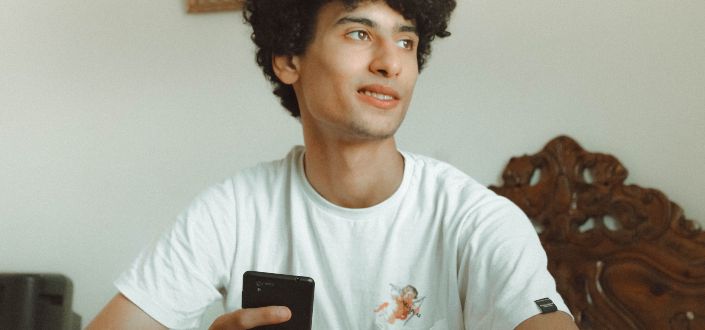 Young man holding black smartphone