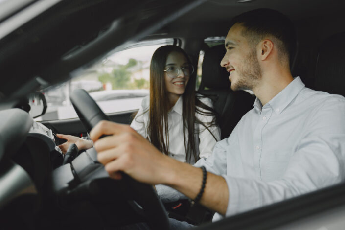 Man and woman sitting inside a car