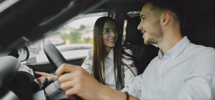 Man and woman sitting inside a car