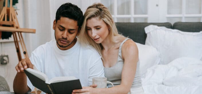 couple reading a book on the couch
