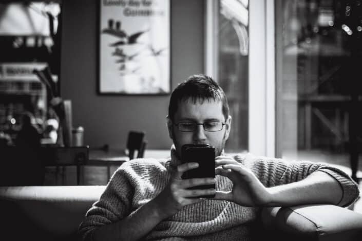 Man looking at his phone while sitting