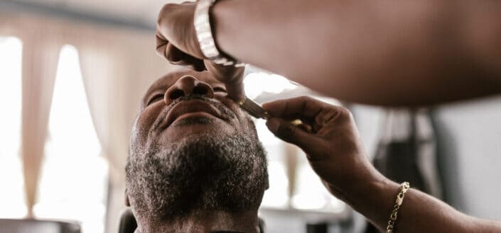 man being shaved by a barber