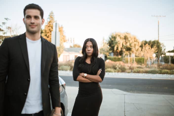 Man in black shirt standing beside woman