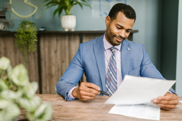 Man holding white paper and ballpen