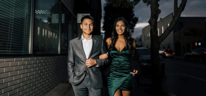 Man standing beside woman in green dress