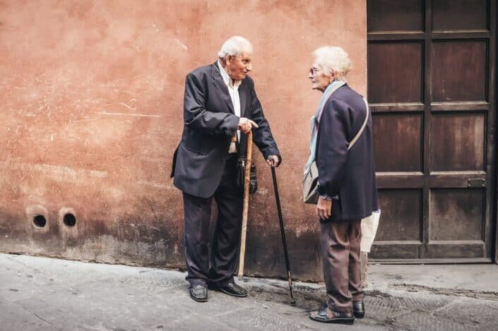 Old couple talking to each other outside the door