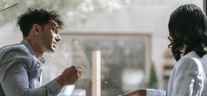 Couple sitting in café drinking coffee