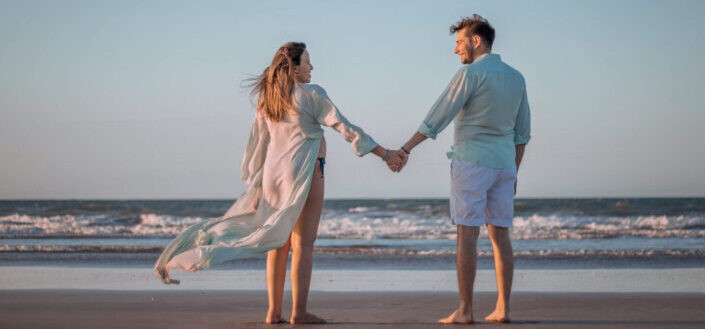 Couple holding hands on a beach