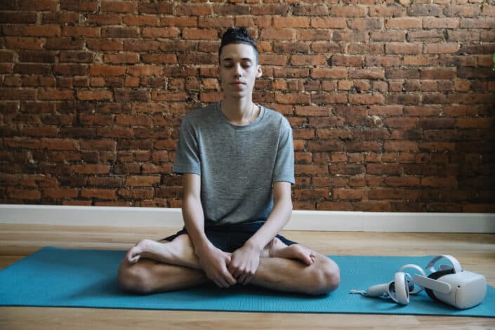 Teen meditating in lotus pose