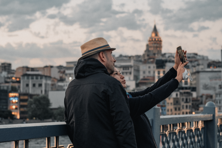 Couple taking a selfie on bridge