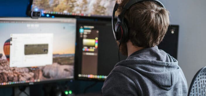 Unrecognizable man working on computer at home