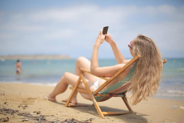 Woman on a beach using her smartphone