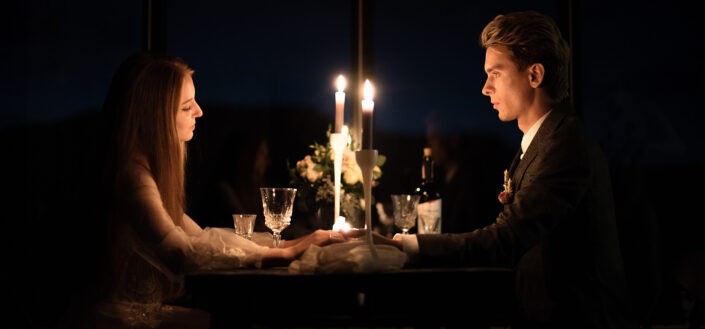 Elegant couple holding hands during romantic dinner