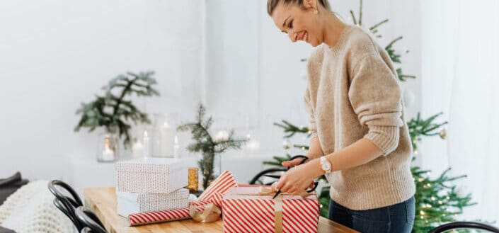 A woman opening a christmas present