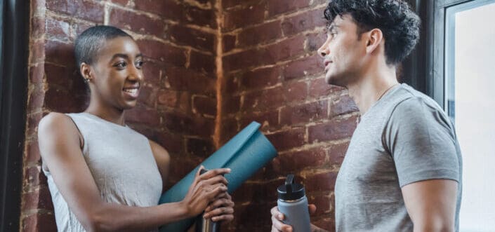 Cheerful couple chatting in gym