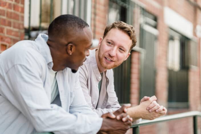 two men talking outside