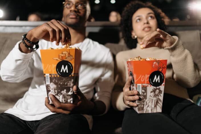 man and woman eating popcorn together