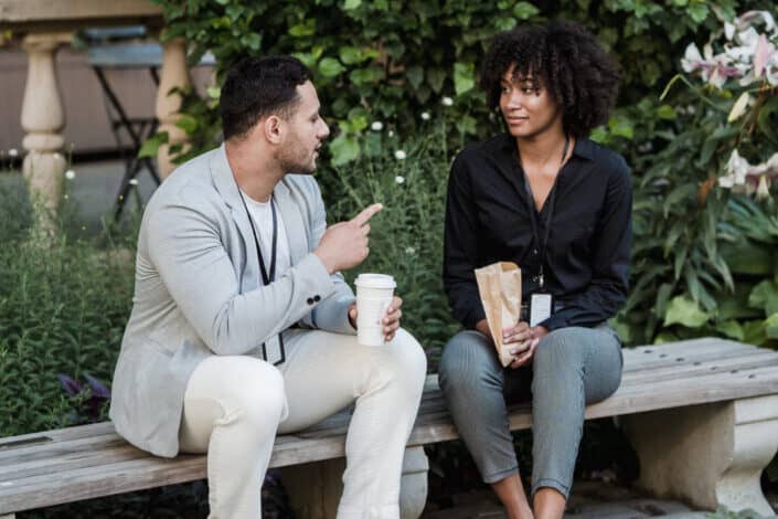 Couple sitting on bench talking