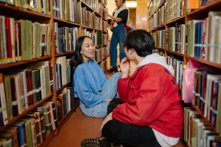 Friends sitting in the library