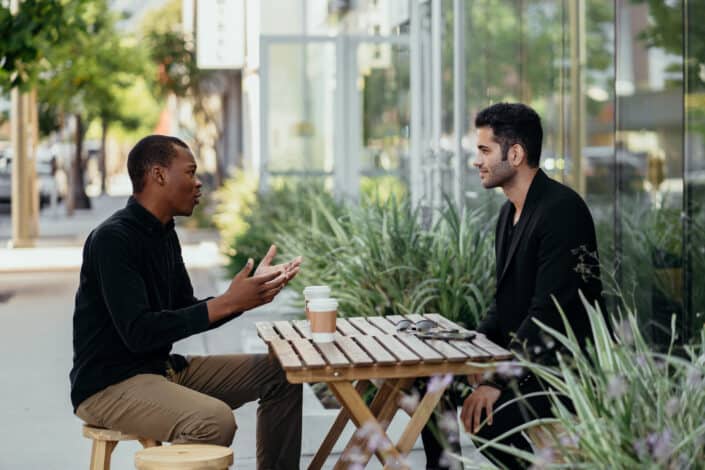 Male colleagues talking to each other