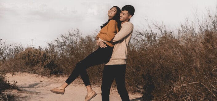 Couple Horsing Around on a Sandy Terrain