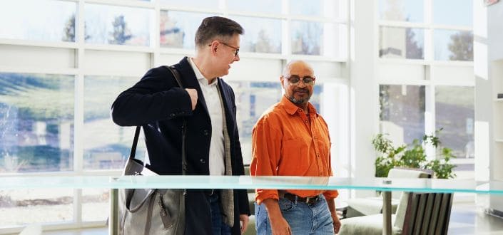 two men standing indoors