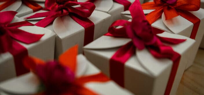 White gift boxes with red ribbon