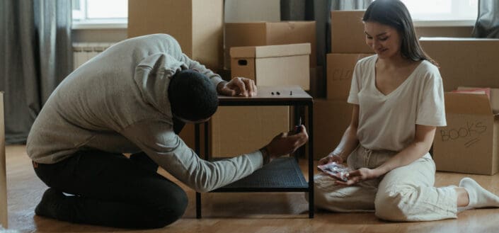 Couple assembling a small wooden table