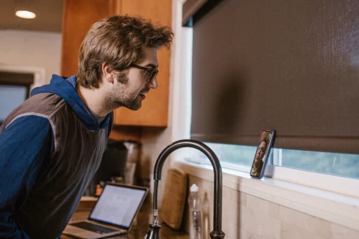 Man on a Video Call Near the Sink