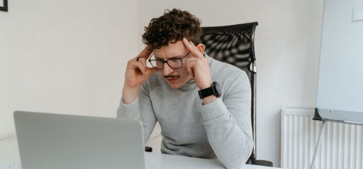 Stressed Man Staring at His Laptop