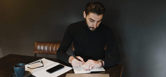 Person Holding a Pen Looking at Watch